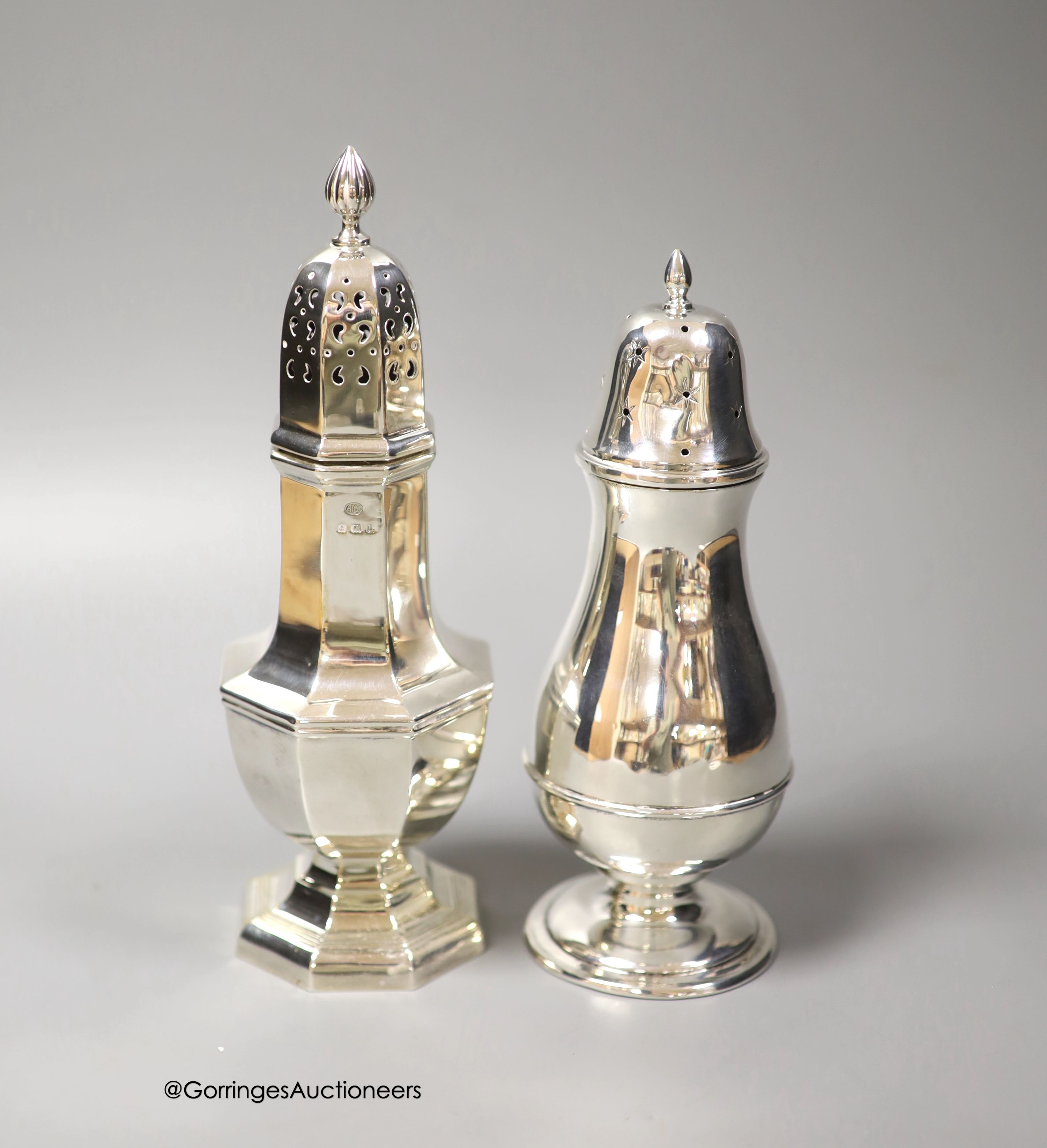 A George V silver panelled sugar caster, Birmingham, 1935, 22.3cm and a smaller earlier silver sugar caster